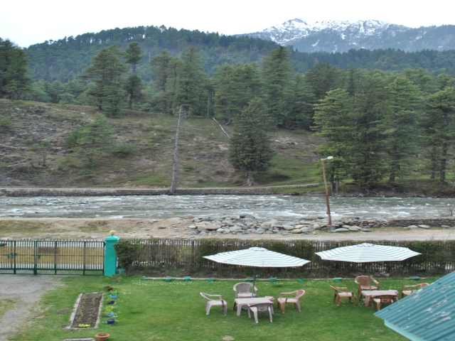 Another view of lawn ,river and forest ,snow peaks from upstairs Rooms